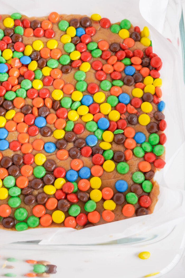 Peanut Butter Fudge Recipe topping fudge with M&Ms