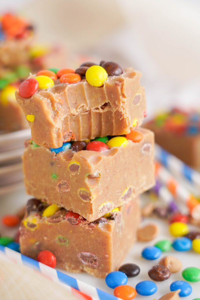 Stacks of Peanut Butter Fudge embedded with M&Ms closely focused and vibrant.