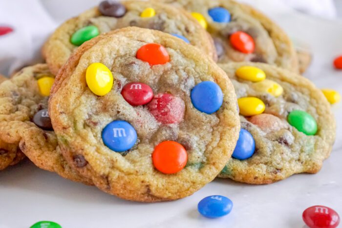 A plate of homemade cookies topped with colorful candy-coated chocolate pieces.